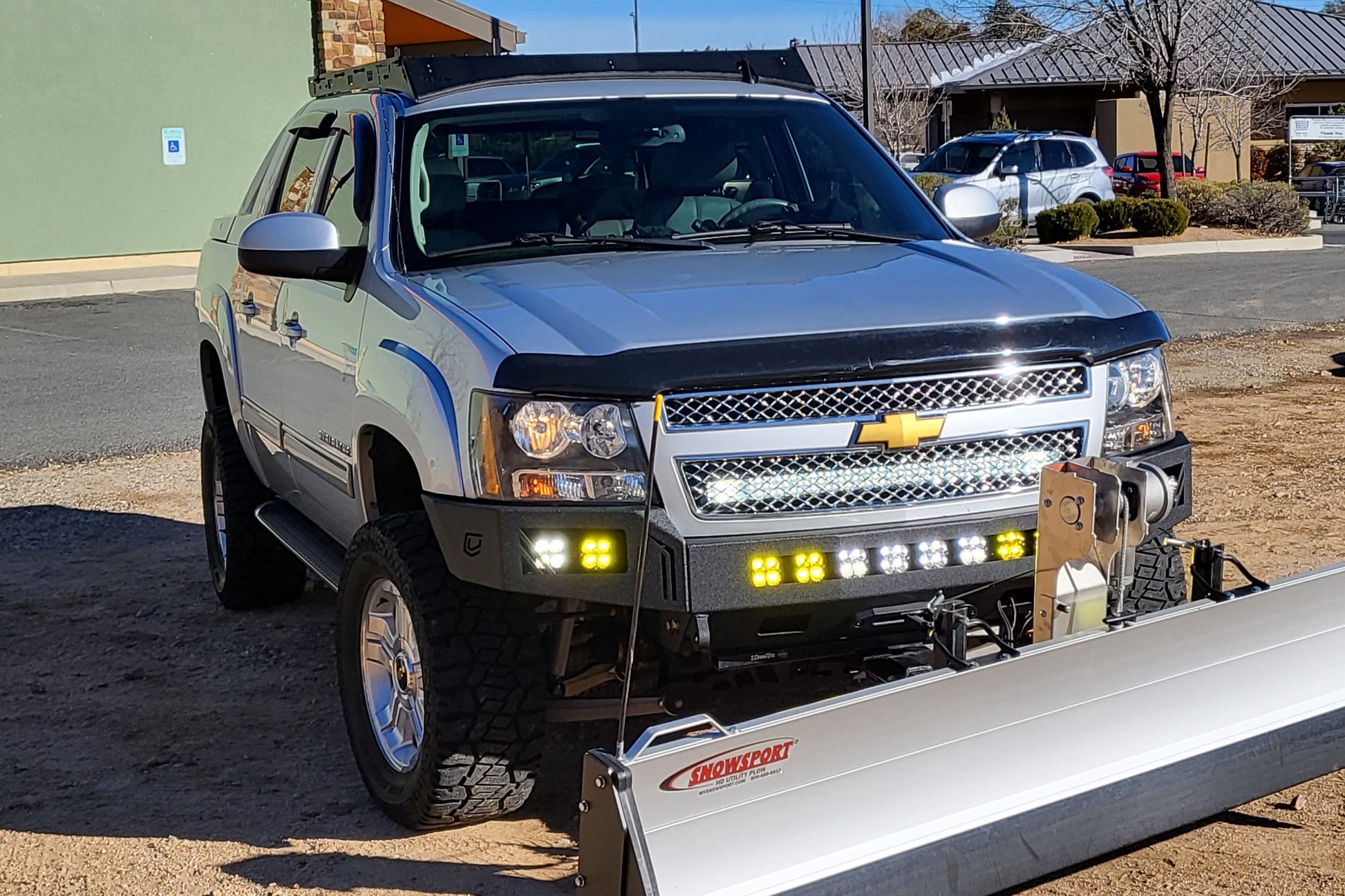 Chevy Avalanche with Baseline Overland Roof Rack, winch bumper, baja designs squadron sport and snow plow
