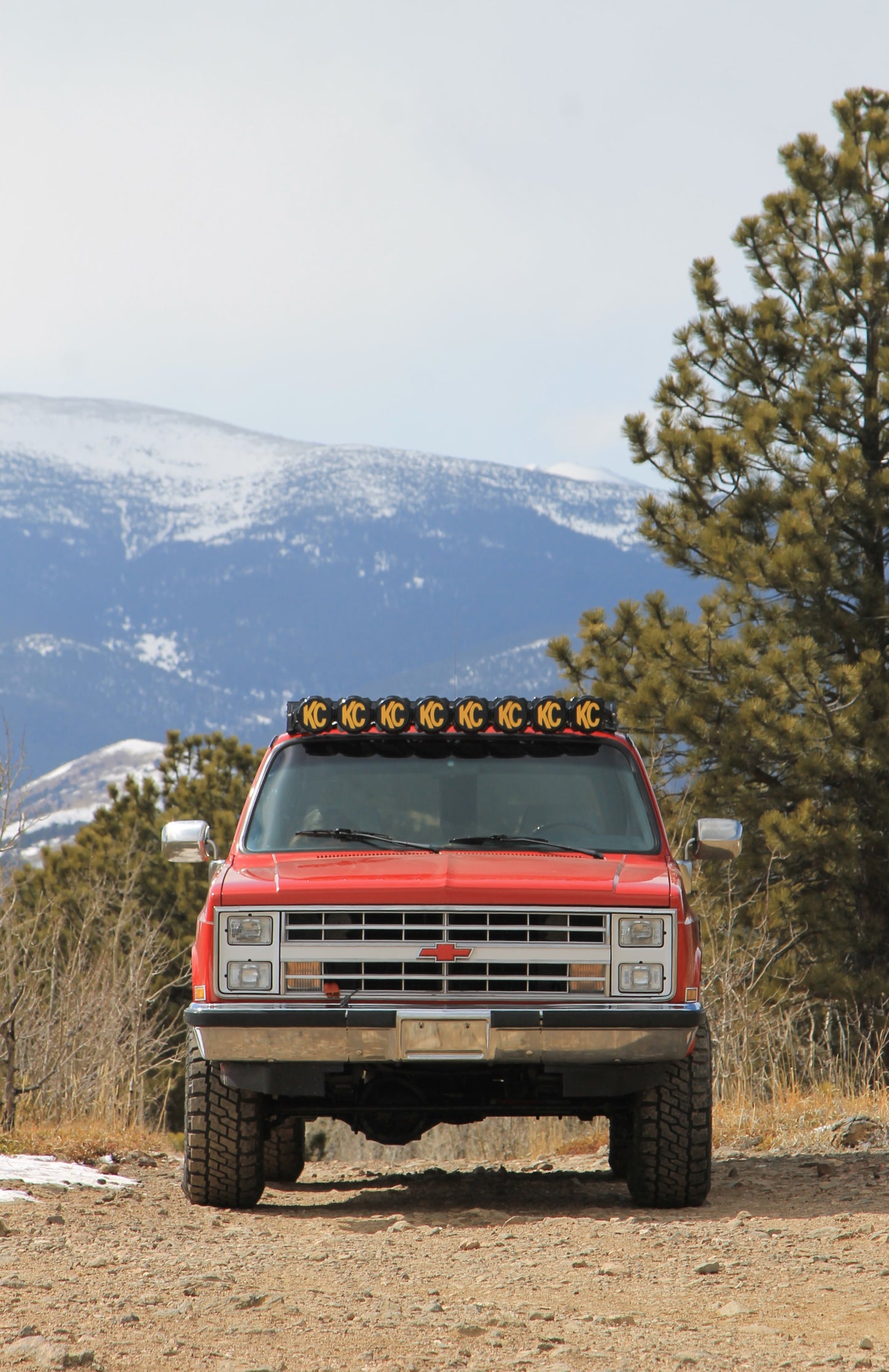 Red 1987 Chevy Suburban with Baseline Overland Roof Rack and KC Gravity Pro Light Bar