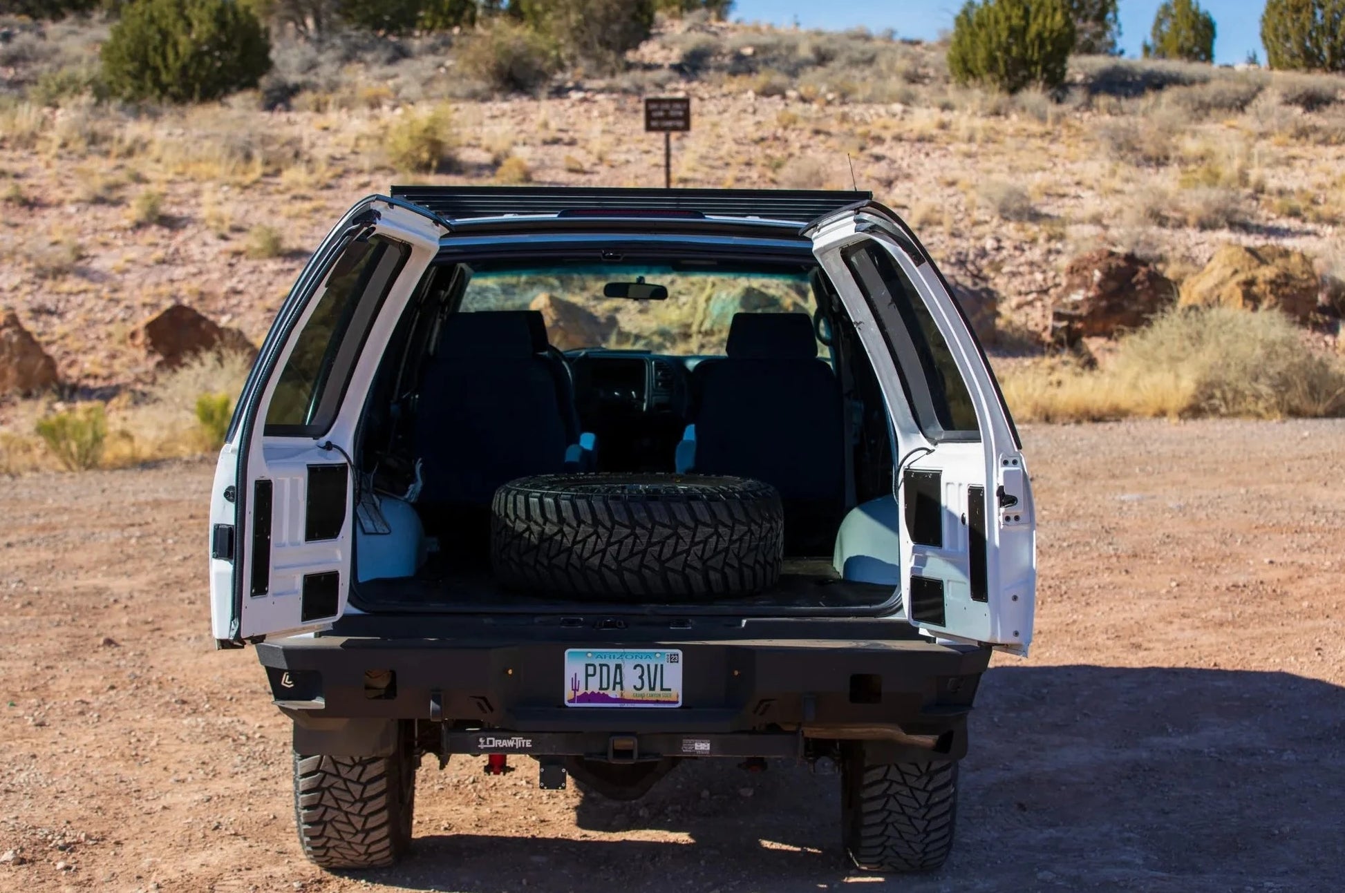 1999 Chevy Suburban Bar Doors Rear Octane Bumper by Chassis Unlimited Baseline Overland with rear barn doors open