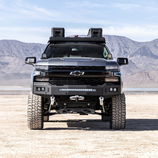 Chevrolet truck with off-road winch bumper in a desert landscape