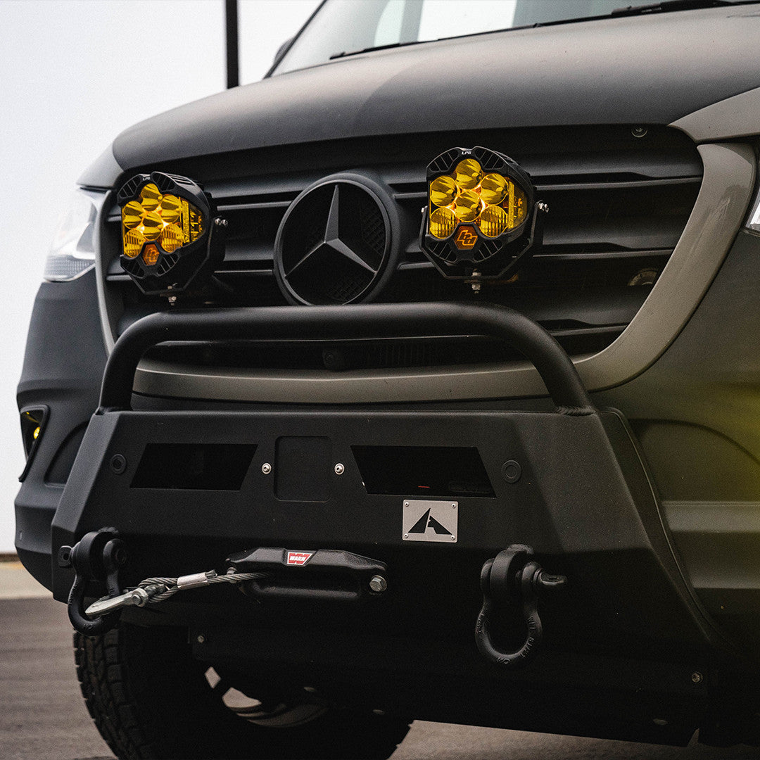 View of the Baja Designs LP6 Pro LED Auxiliary Light Pod, Mounted on a Sprinter Van bumpershowcasing its rugged design and six powerful LED lights and green backlight