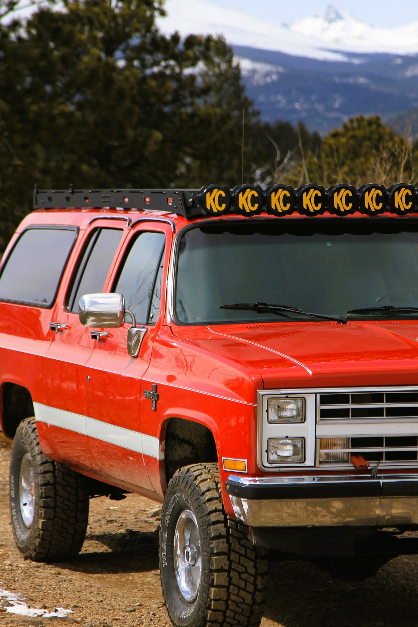 Red 1987 Chevy Suburban with Baseline Overland Roof Rack and KC Gravity Pro Light Bar