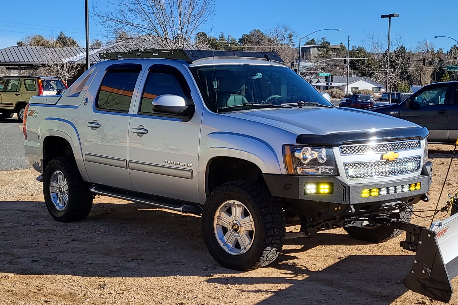 Chevy Avalanche with Baseline Overland Roof Rack, winch bumper, baja designs squadron sport and snow plow